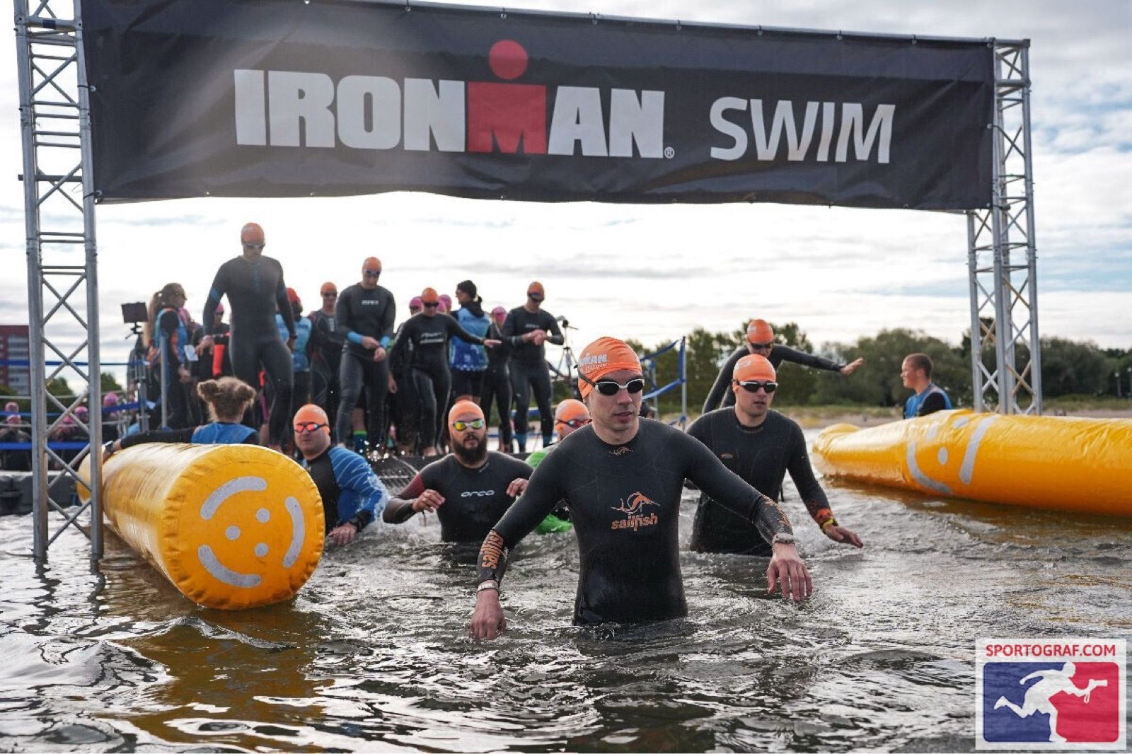 Exiting the swim under the IRONMAN SWIM banner.
